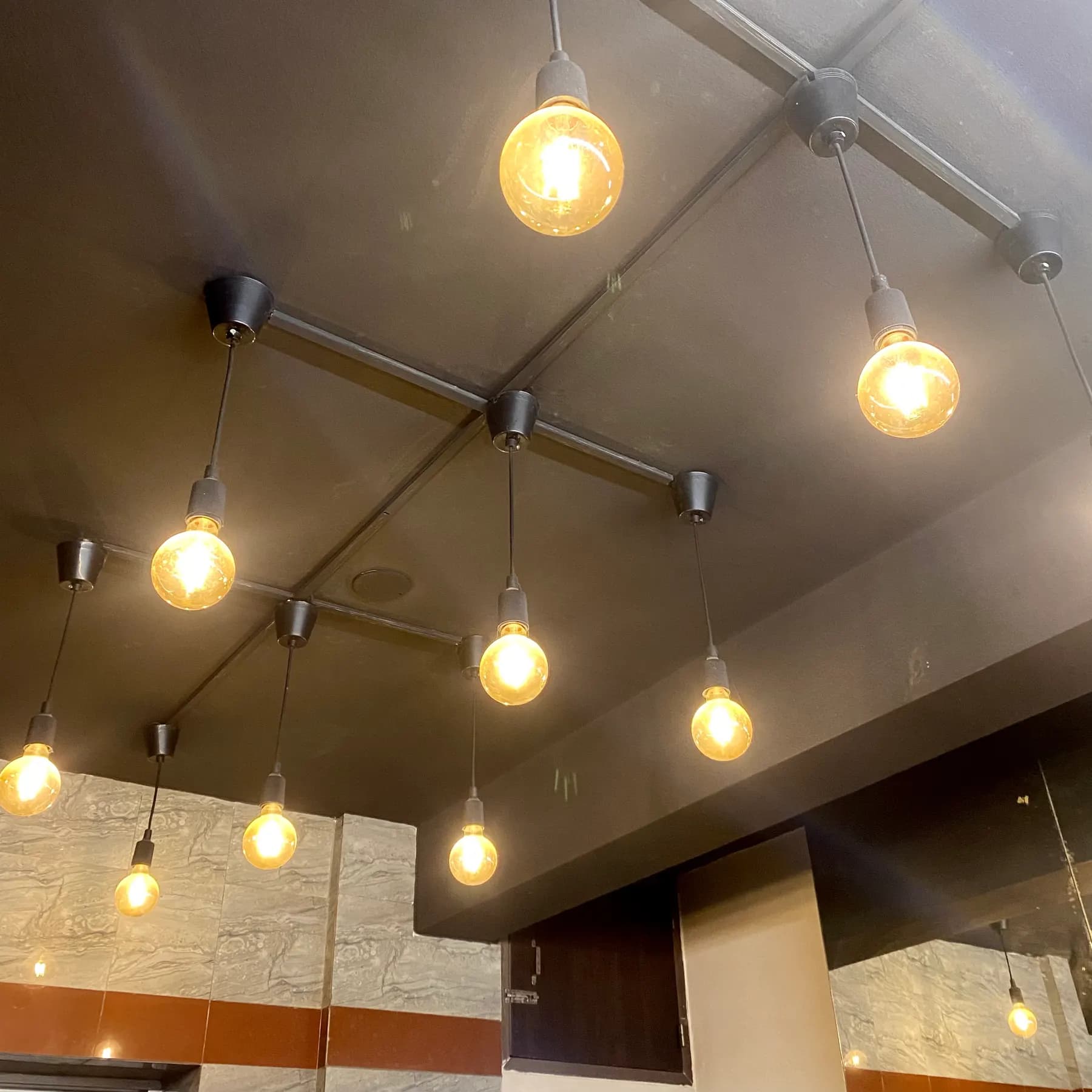 Track lighting with warm bulbs lit across a modern ceiling